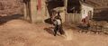 Bayek carrying the Hidden One's body out of the fort
