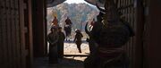 Yasuke passes by Valignano and Fróis at the gate