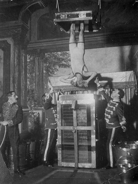 File:AC2 - Houdini beginning the Water Torture Cell.jpg