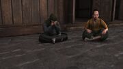 A seated Sadatame guarded by his servant