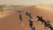 Taharqa leading Bayek and a group of men to the Reavers' hideout