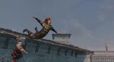 Ezio pulls a guard off a rooftop using the Hookblade