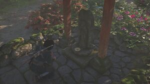 ACSH Naoe making offering at a Jizo Statue.jpg