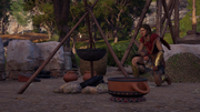 Kassandra preparing a Pankration fighter's body oil.