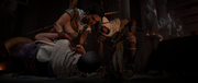 Aya and Bayek tending to a mortally wounded Apollodorus