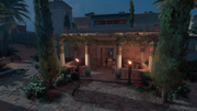 Kawab inviting Bayek to a family dinner inside the house