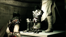 Ezio looks at Altaïr's statue and armor.